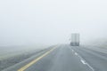 Semi-Truck Drives Into Dense Fog Royalty Free Stock Photo