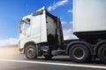 Semi Truck Driving on Highway Road with a Blue Sky. Industry Road Freight Truck. Logistics and Cargo Transport Concept. Royalty Free Stock Photo