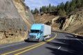 SEMI TRUCK DRIVING ON MOUNTAIN HIGHWAY Royalty Free Stock Photo