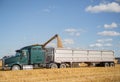 Semi truck parked and being loaded with grain