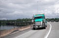 Semi truck rig driving on long bridge across Columbia River Royalty Free Stock Photo