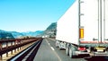 Semi truck speeding on empty highway line - Transport logistic concept with semitruck container driving on speedway - Focus on