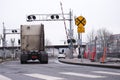 Semi truck tractor moving by railroad crossing Royalty Free Stock Photo