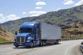 Semi truck with trailer driving on highway Royalty Free Stock Photo
