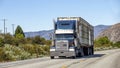 Semi truck with trailer driving on highway Royalty Free Stock Photo