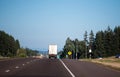 Semi truck with semi trailer running away by straight highway Royalty Free Stock Photo