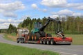 Semi Truck Transports Forestry Harvester at Spring Royalty Free Stock Photo