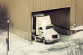 Semi truck and the warehouse seen winter time Royalty Free Stock Photo