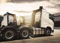 Semi Trucks Parked with Sunset Sky. Shipping Trucks. Engine Diesel Truck. Lorry Tractor. Freight Trucks Logistics Transport. Royalty Free Stock Photo