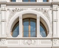 Semicircle white window crossed by decorated columns. Royalty Free Stock Photo