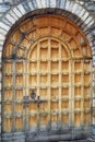 Traditional window with wooden shutters and pots with flowers on the wall of the old town in Budva. Blurred foreground Royalty Free Stock Photo