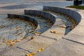 Semicircular stone steps with fallen yellow foliage Royalty Free Stock Photo