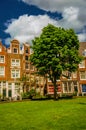 Semidetached typical houses and green garden at Begijnhof, a medieval semi-monastic community in Amsterdam. Royalty Free Stock Photo