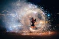 SEMIGORYE, IVANOVO OBLAST, RUSSIA - JUNE 26, 2018: Fire show. Girl spins fiery sparkling torches