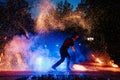 SEMIGORYE, RUSSIA - JUNE 17, 2022: Fire show at night at festival event. Man with torches arranges a pyrotechnic Royalty Free Stock Photo