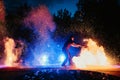 SEMIGORYE, RUSSIA - JUNE 17, 2022: Fire show at night at festival event. Man with torches arranges a pyrotechnic Royalty Free Stock Photo