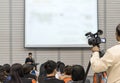 Seminar training workshop event video recording camera man with speaker lecturer giving business talk, presentation speech Royalty Free Stock Photo