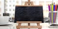 Seminars concept. Blackboard on easel against blur office background, copy space Royalty Free Stock Photo