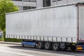 Semitrailer with white tarpaulin without inscriptions, standing on the street. Royalty Free Stock Photo