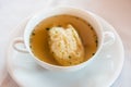 Semolina Dumpling Soup, Beef Broth in a White Bouillon Cup