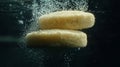 Semolina grains float separately underwater as air bubbles rise them creating captivating visual dark backdrop