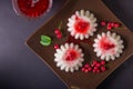 Semolina pudding in a brown square plate with red currant syrup and berries. On a dark background Royalty Free Stock Photo