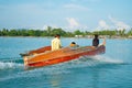 Orange boat speeding across bay