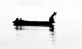 Silhouette of lady belonging to Bajau tribal community rowing boat in Semporna Sea, Sabah Semporna, Malaysia