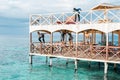 Semporna, Malaysia - November 26, 2019: Kids jumping off  from the second floor terrace into the sea. Having fun on a school Royalty Free Stock Photo