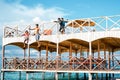 Semporna, Malaysia - November 26, 2019: Kids jumping off  from the second floor terrace into the sea. Having fun on a school Royalty Free Stock Photo