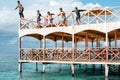 Semporna, Malaysia - November 26, 2019: Kids jumping off  from the second floor terrace into the sea. Having fun on a school Royalty Free Stock Photo