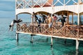 Semporna, Malaysia - November 26, 2019: Kids jumping off from the second floor terrace into the sea. Having fun on a school