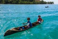 Unidentified local BAJAU LAUT people on wooden boat