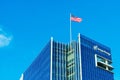 Sempra Energy corporate headquarters building facade. U.S. Flag proudly waving atop energy infrastructure company office under Royalty Free Stock Photo