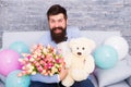 Send flowers like you mean it. Flower for March 8. Bearded man with tulip bouquet and bear. Love date. international