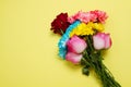 Send flowers online concept. Flower delivery for valentine and mother day. Bouquet of red pink roses isolated on yellow background