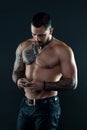 Send message. Handsome fit man send message smartphone. Muscular tattooed athlete look attractive. Messaging