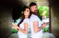 Send provocative message. Couple ignore real communication. Couple chatting smartphones. Girl and bearded man stand back