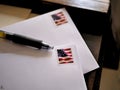 American Flag Stamps on Mail Envelopes and Pen