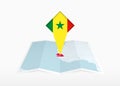 Senegal is depicted on a folded paper map and pinned location marker with flag of Senegal