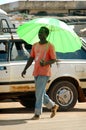 SENEGAL - JUNE 12: A man walking in the street with an umbrella