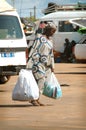 SENEGAL - JUNE 12: A woman walking in the street with big bags o