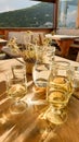 Senes - Homemade white wine in a white carafe with a few glasses, placed on a wooden table in a mountain cottage in Dolomites