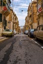 Narrow charming street in Senglea decorated with religious festoons for village feast