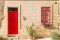 Senglea, Malta - Traditional red door and window of an old maltese house at Senglea