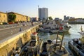 Senigallia, Italy: Boats in the port during sunrise. Senigallia marina across buildings. Canal in Senigallia