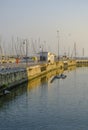 Senigallia, Italy: view of the canal on the sunrise over the yachts in boats in port and flying seagulls.