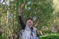 Senior active man plays with soap bubbles outdoor Royalty Free Stock Photo