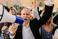 Senior activist man with a megaphone leading protest against climate change