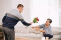 senior adult couple lover cute gentle man surprise giving roses flower for wedding anniversary or valentine days to his wife at